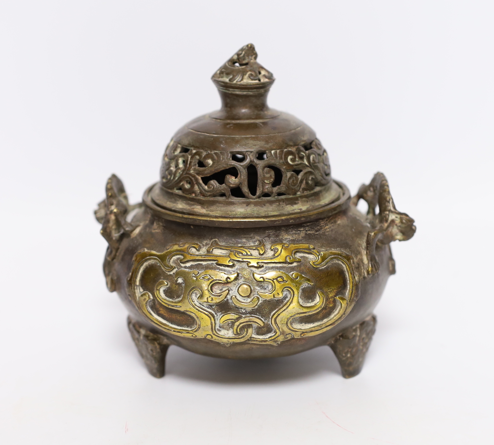 A Chinese parcel gilt bronze censer, with pierced lid and twin zoomorphic handles, 15cm high